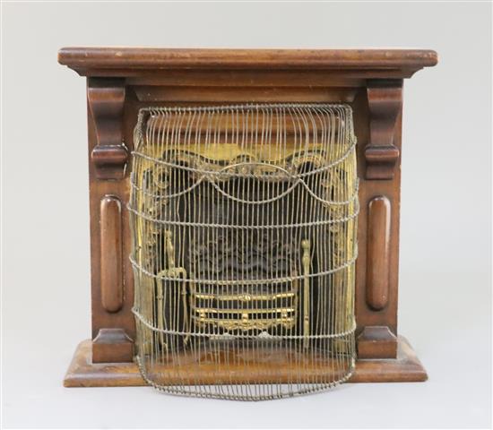 A late Victorian mahogany miniature fireplace, 11.5in. height 10.75in., with associated wirework fire guard